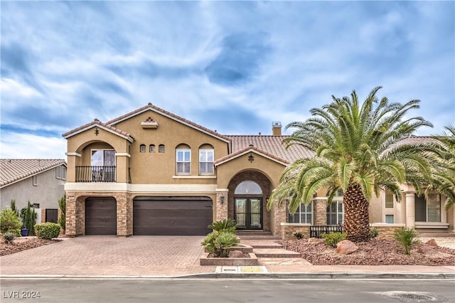 mediterranean / spanish-style home with a garage