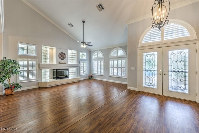 unfurnished living room with french doors, dark hardwood / wood-style flooring, high vaulted ceiling, and a wealth of natural light