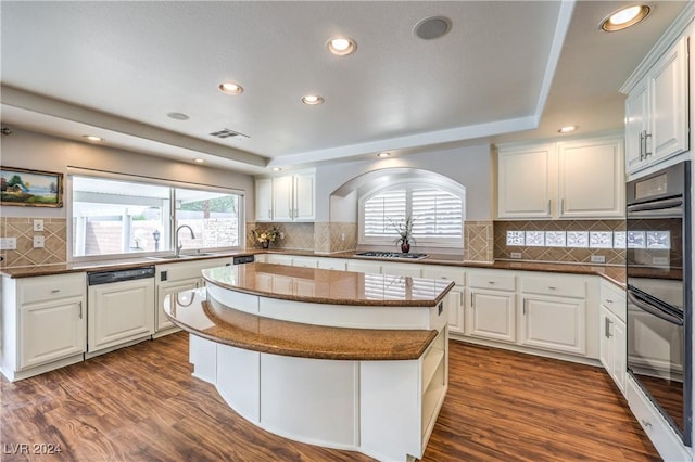 kitchen featuring white cabinets, a center island, and hardwood / wood-style floors