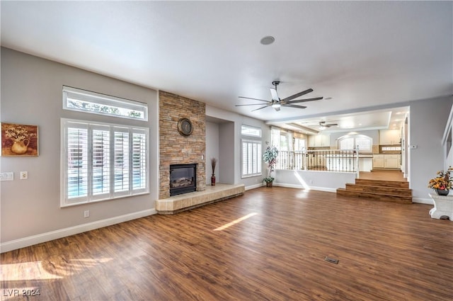 unfurnished living room with ceiling fan, wood-type flooring, and a fireplace