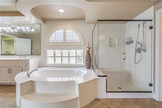 bathroom with plus walk in shower, vanity, and tile patterned floors