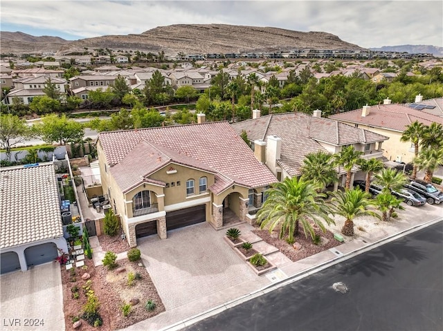 birds eye view of property with a mountain view