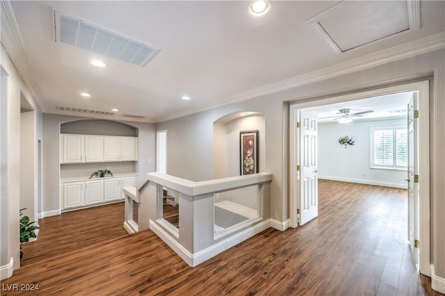 hall with dark hardwood / wood-style flooring and ornamental molding