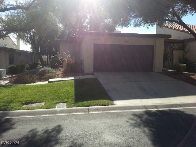 view of front of home with a garage and a front yard