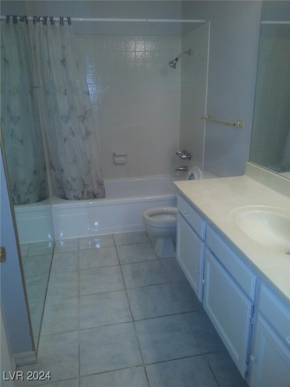 full bathroom with tile patterned flooring, shower / bath combination with curtain, vanity, and toilet