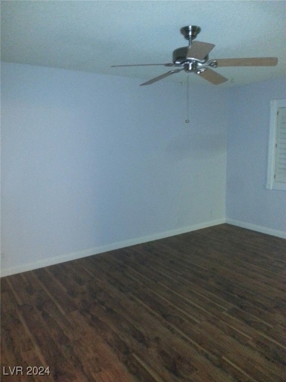 unfurnished room featuring dark hardwood / wood-style floors and ceiling fan