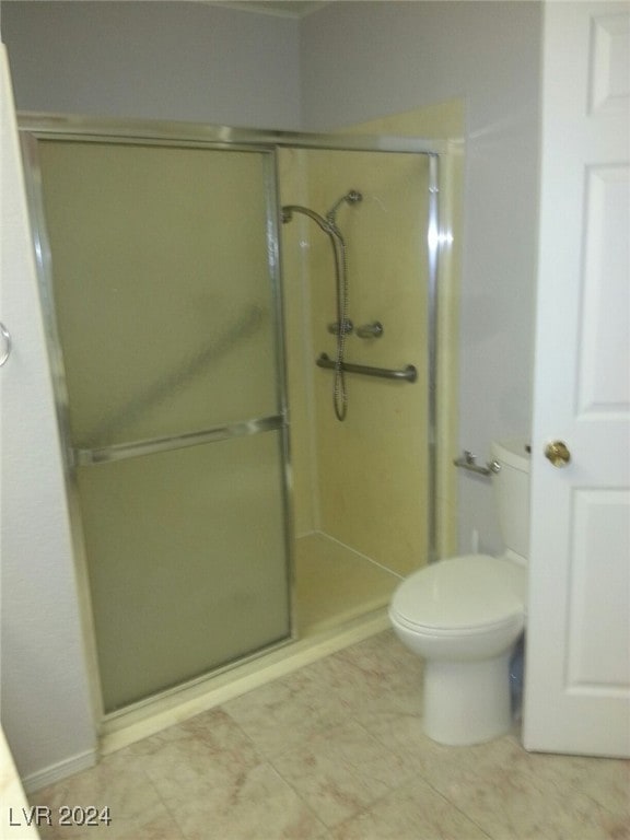 bathroom featuring toilet and walk in shower