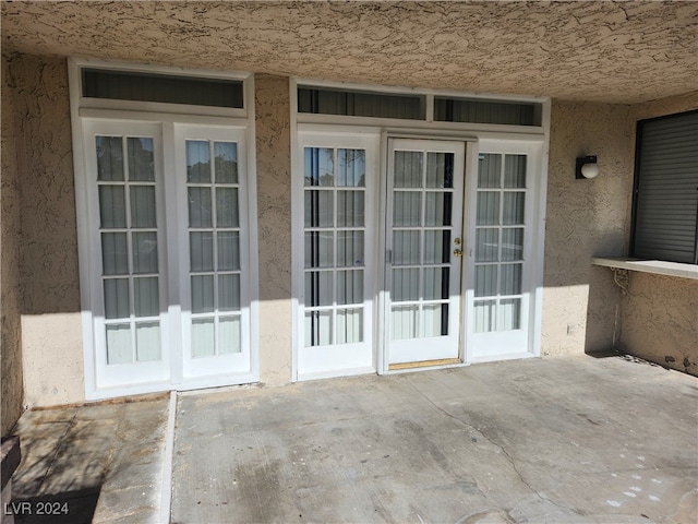 entrance to property with french doors and a patio