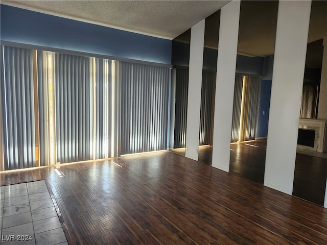 spare room with hardwood / wood-style flooring and a textured ceiling