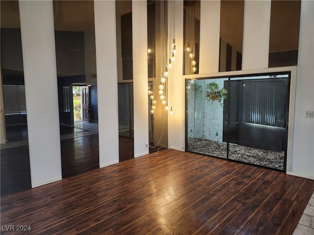 interior space featuring hardwood / wood-style floors and high vaulted ceiling