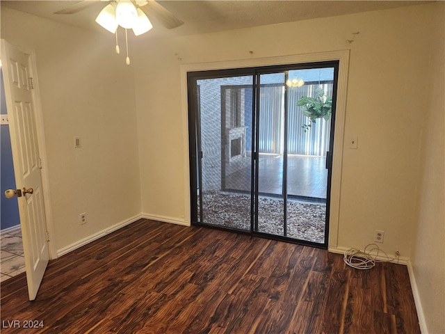 unfurnished room featuring ceiling fan and dark hardwood / wood-style flooring