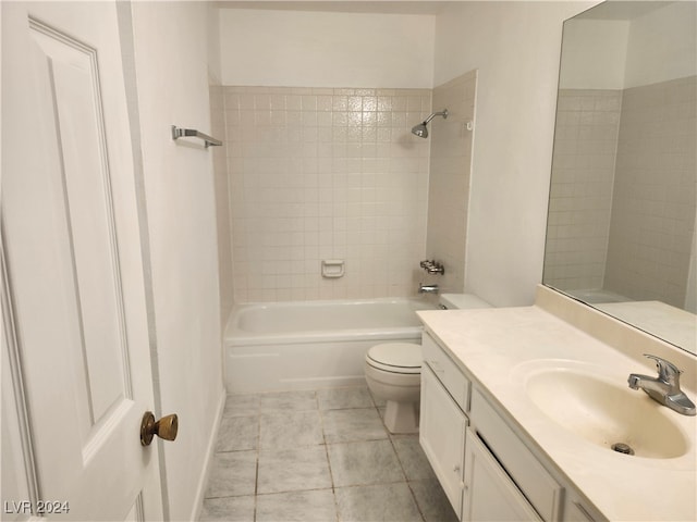 full bathroom featuring tile patterned floors, vanity, tiled shower / bath combo, and toilet