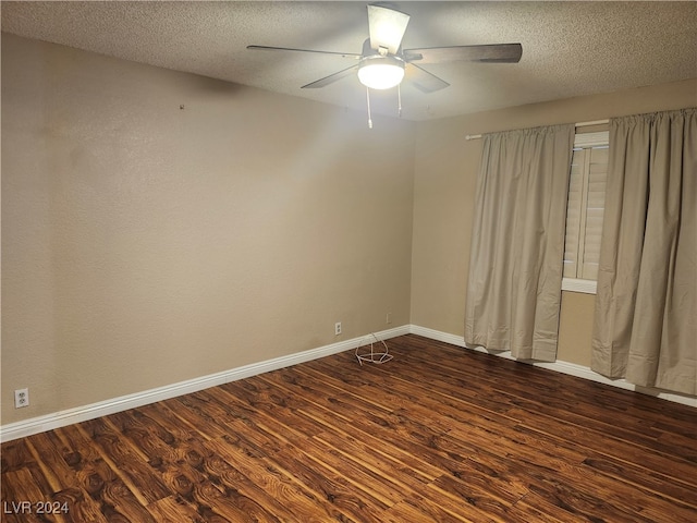 unfurnished room featuring dark hardwood / wood-style floors, ceiling fan, and a textured ceiling