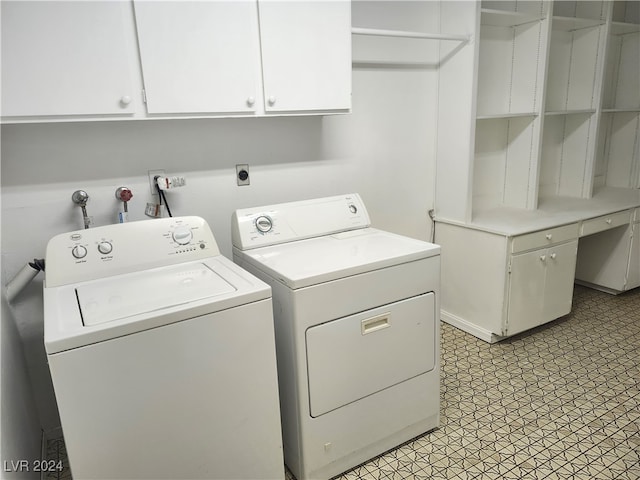 laundry area featuring washer and dryer and cabinets