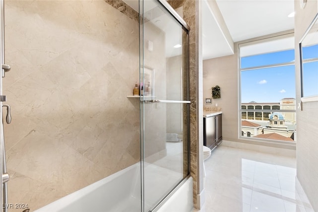 full bathroom featuring vanity, shower / bath combination with glass door, toilet, and tile patterned flooring