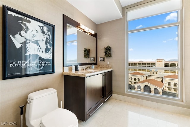 bathroom with vanity, toilet, and tile patterned floors