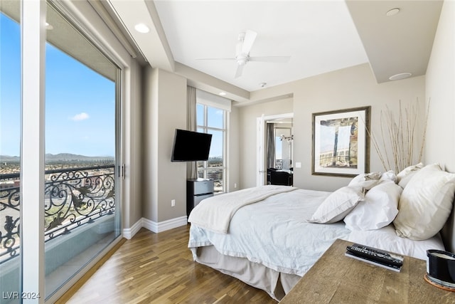 bedroom with ceiling fan, access to exterior, and hardwood / wood-style floors