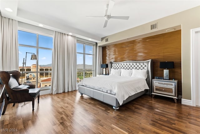 bedroom with ceiling fan and dark hardwood / wood-style flooring