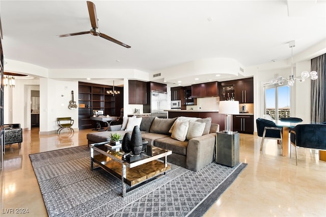 living room featuring ceiling fan with notable chandelier