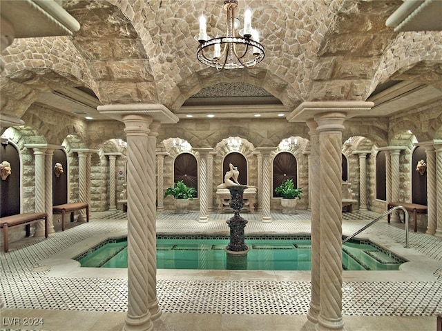 view of pool featuring an indoor hot tub and ornate columns