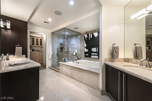 bathroom with vanity and independent shower and bath