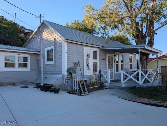 bungalow featuring a patio area