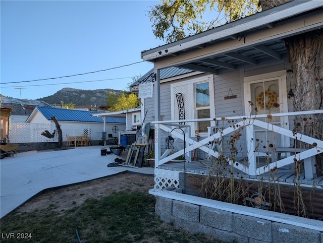 exterior space featuring a mountain view and a patio