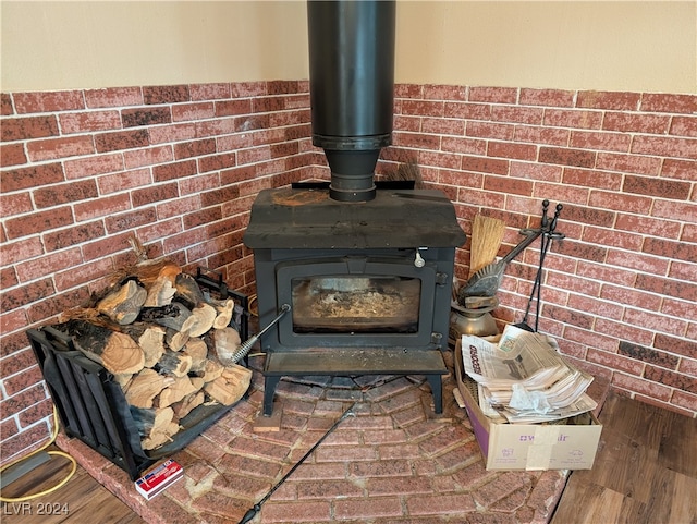 interior details with a wood stove and hardwood / wood-style flooring