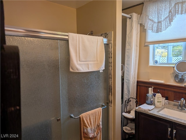 bathroom featuring vanity and curtained shower