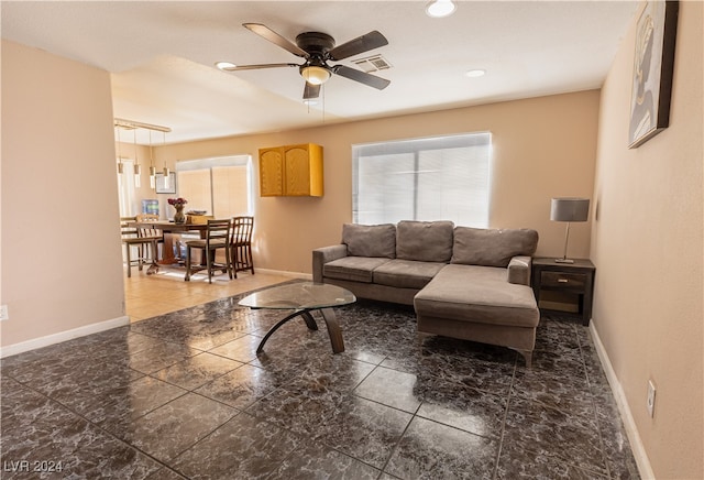 living room with a healthy amount of sunlight and ceiling fan