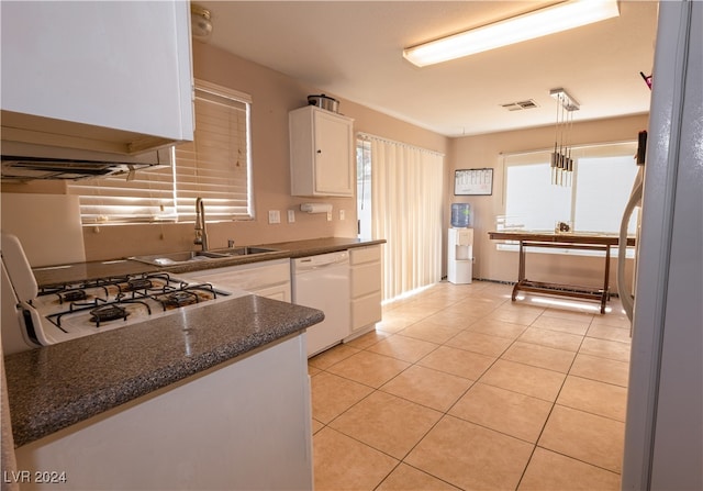 kitchen with white appliances, sink, white cabinetry, decorative light fixtures, and light tile patterned floors