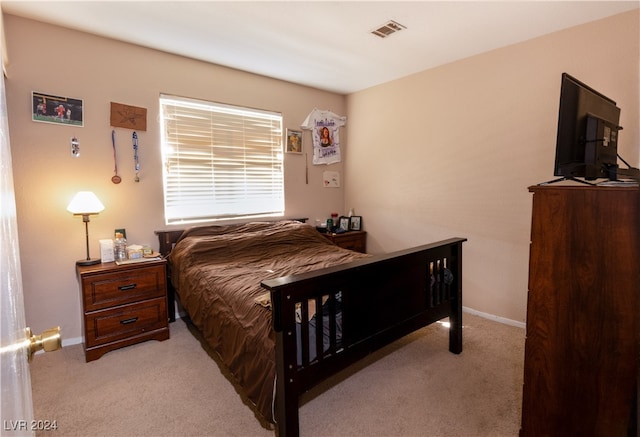 bedroom with light colored carpet