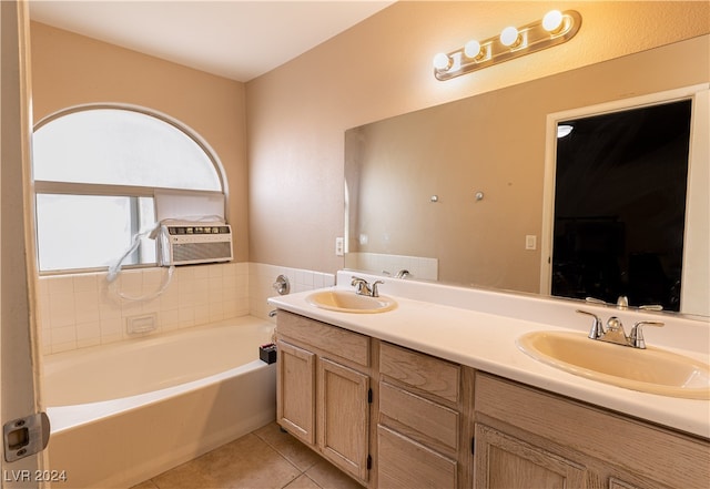 bathroom featuring vanity, a tub to relax in, and tile patterned flooring