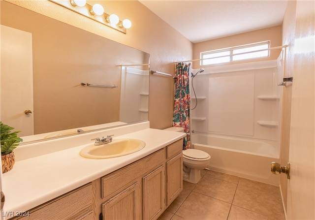 full bathroom featuring toilet, shower / bath combo with shower curtain, vanity, and tile patterned floors