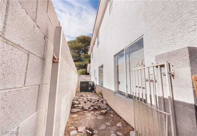 view of side of property with central air condition unit