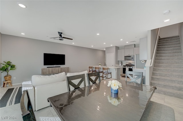 dining room featuring ceiling fan and light tile patterned floors