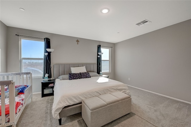 carpeted bedroom featuring multiple windows