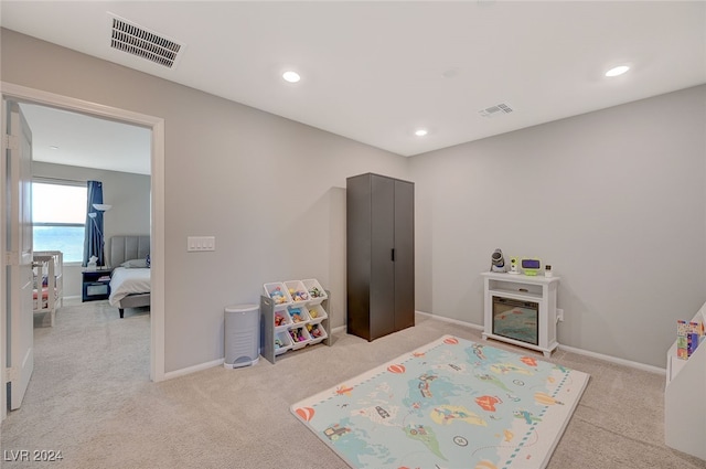 playroom featuring light carpet and a water view