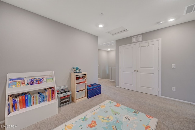 rec room with light colored carpet