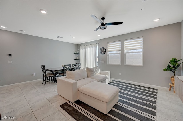 living room featuring light tile patterned floors and ceiling fan