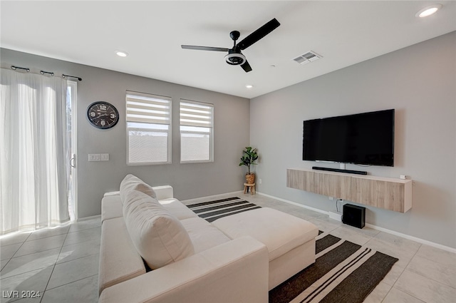 tiled living room with ceiling fan