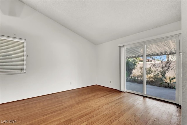 spare room featuring a textured ceiling and light wood-type flooring