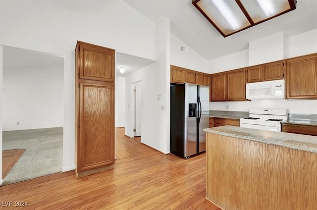 kitchen featuring light stone countertops, light hardwood / wood-style floors, high vaulted ceiling, and white appliances