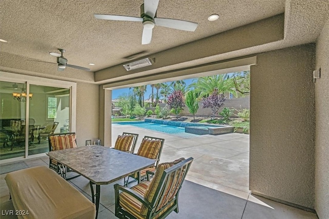 view of patio featuring ceiling fan and a pool with hot tub