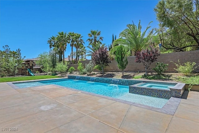 view of swimming pool featuring a playground, an in ground hot tub, and pool water feature