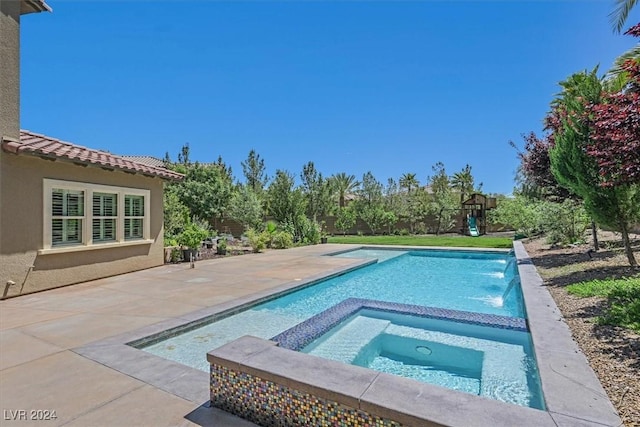 view of pool featuring an in ground hot tub, pool water feature, and a patio area