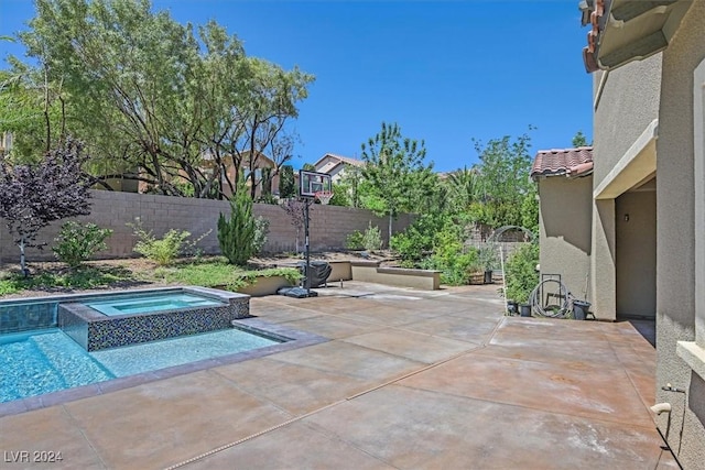 view of patio / terrace with a swimming pool with hot tub