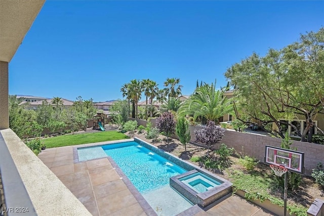 view of swimming pool featuring an in ground hot tub