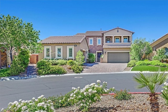 mediterranean / spanish-style home with a garage