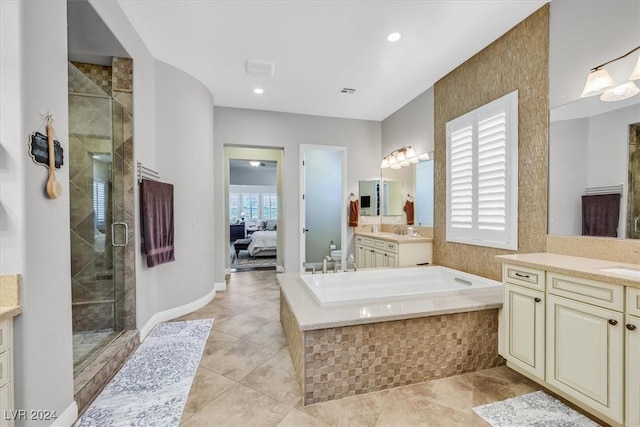 bathroom featuring plenty of natural light, vanity, independent shower and bath, and tile patterned flooring